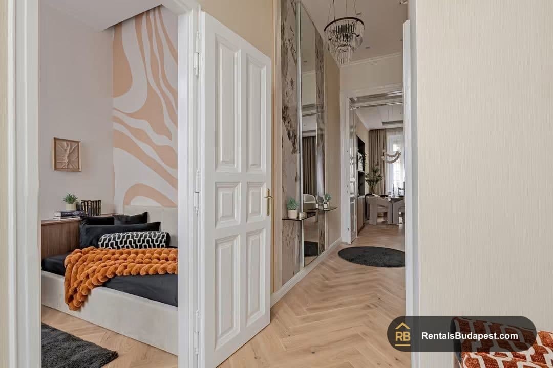 Hallway with open white panel door showing striped-wall bedroom and marble mirror panels, Falk Miksa utca