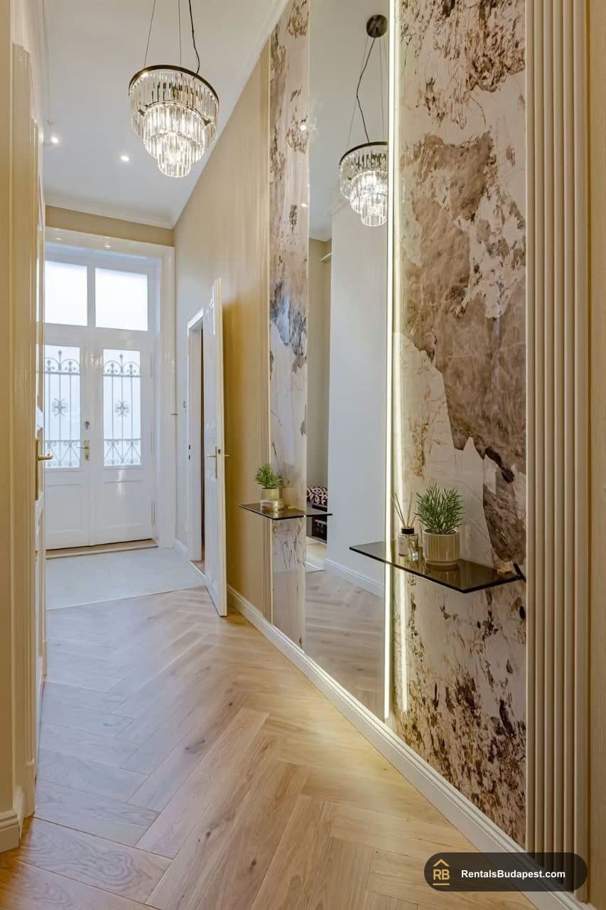 Long hallway with marble-patterned wall, mirrored panel, glass shelves and chandelier, Falk Miksa utca
