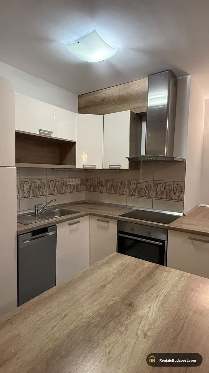Kitchen with white upper cabinets, wood-look worktop, stainless steel hood and built-in oven, Viola utca