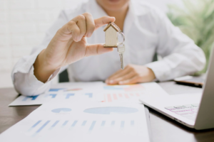 Smiling landlord looking at property management reports at home